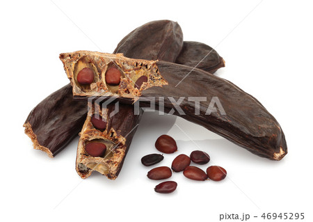 Ripe carob pods and seeds on white background Ripe carob pods and seeds on white background 46945295