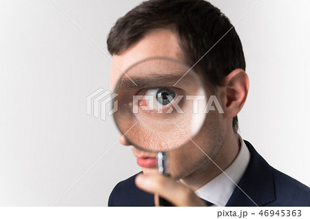 虫眼鏡で見る男性 46945363