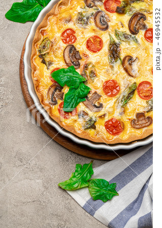 Baked homemade quiche pie in ceramic baking form Baked homemade quiche pie in ceramic baking form 46945532