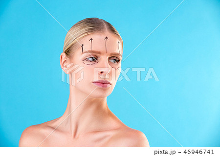 Beautiful Woman Face. Beauty Portrait of young woman blond, painted lines on the face for cosmetic Beautiful Woman Face. Beauty Portrait of young woman blond, painted lines on the face for cosmetic 46946741