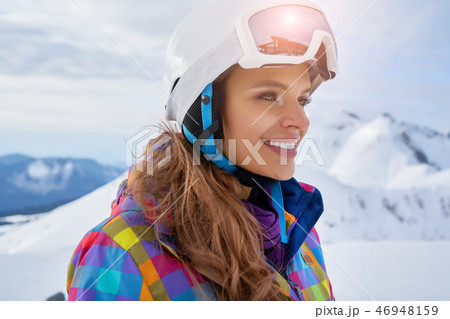 Woman Skier Standing at Snow Looking at Camera. Winter Montain 46948159