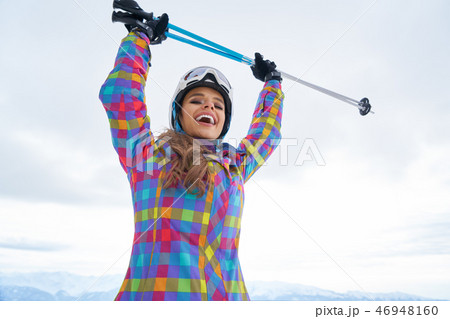 Woman Skier Standing at Snow Looking at Camera. Winter Montain Woman Skier Standing at Snow Looking at Camera. Winter Montain 46948160