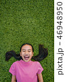 kid asian girl's lie leisurely on the Lawn floor 46948950