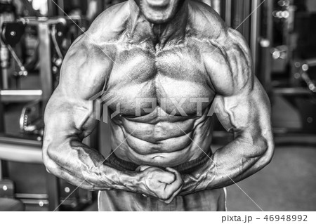 Brutal aged strong bodybuilder athletic men pumping up muscles w 46948992