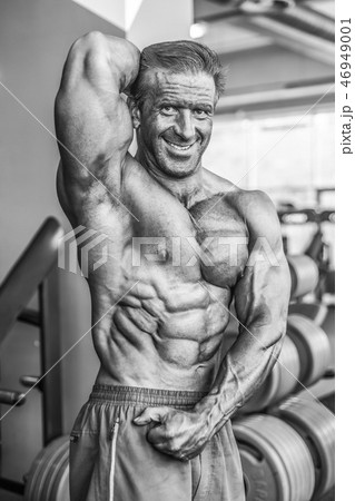 Brutal aged strong bodybuilder athletic men pumping up muscles w 46949001