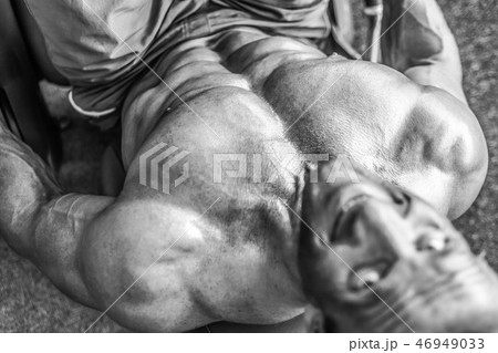 Brutal aged strong bodybuilder athletic men pumping up muscles w 46949033