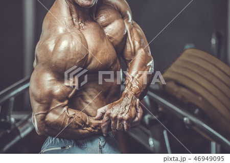 Brutal aged strong bodybuilder athletic men pumping up muscles w Brutal aged strong bodybuilder athletic men pumping up muscles w 46949095