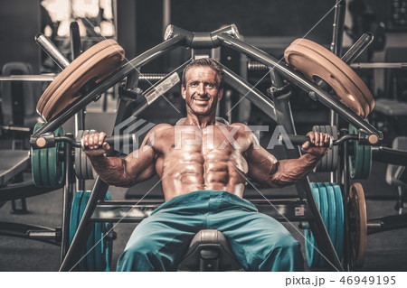 Brutal aged strong bodybuilder athletic men pumping up muscles w 46949195