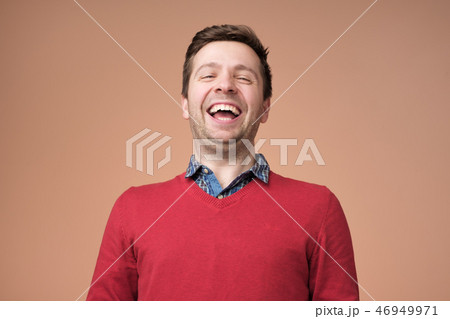 Portrait of a handsome young man laughing 46949971