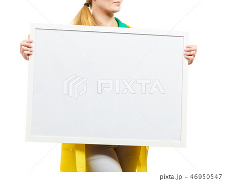 Happy cheerful woman holding blank white board Happy cheerful woman holding blank white board 46950547