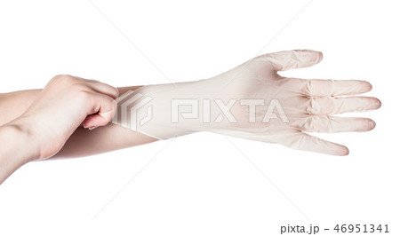 top view of hand pulls latex glove on another hand 46951341