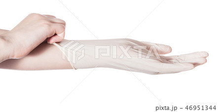profile view of hand pulls latex glove on hand profile view of hand pulls latex glove on hand 46951344