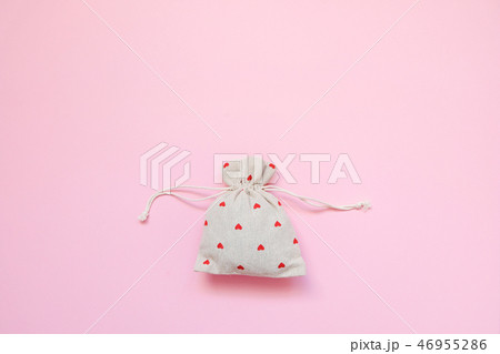 Linen bag with red hearts on pink background. Linen bag with red hearts on pink background. 46955286