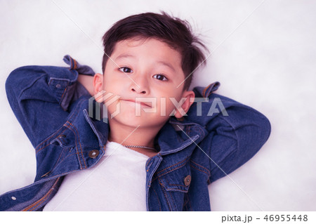 Happy Asian boy wearing jeans jacket copy space. 46955448
