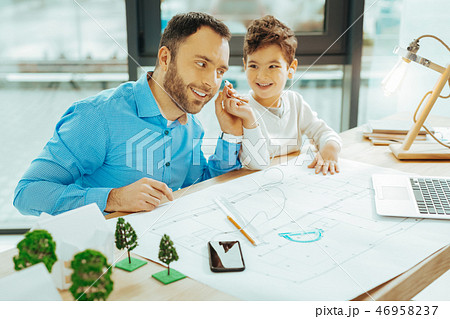 Happy relatives sitting at the table and listening to music Happy relatives sitting at the table and listening to music 46958237