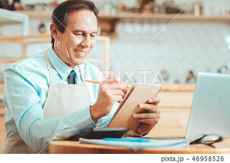 Inspired owner sitting with notebook 46958526