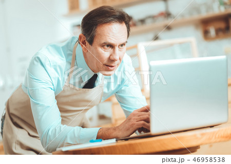 Smiling man making business plan 46958538