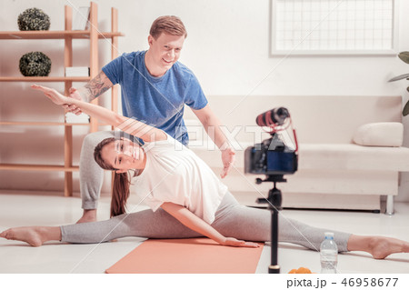 Tattoed man instructing a young woman 46958677