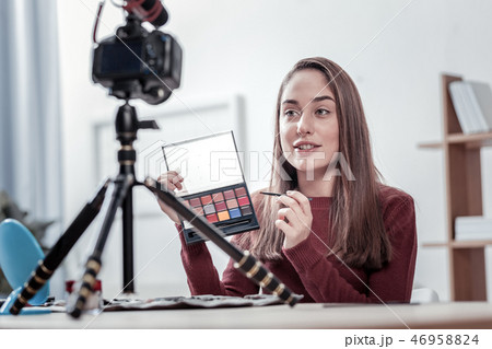 Attractive woman telling about new eye shadows 46958824