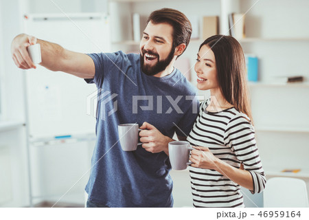 Joyful bearded man taking a selfie 46959164