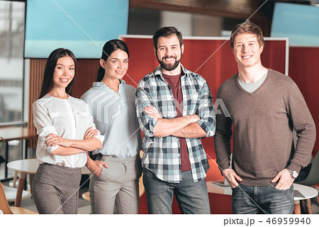 Pleasant happy students standing together Pleasant happy students standing together 46959940