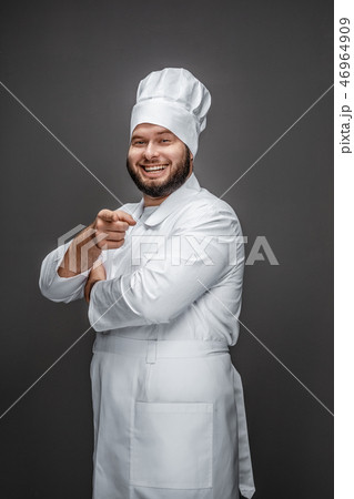 Laughing chef pointing at camera 46964909
