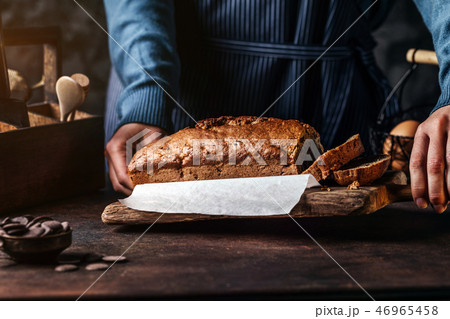 Person serving board with sliced bread Person serving board with sliced bread 46965458