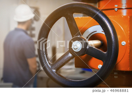 power station worker. man engineer in helmet and shirt twist gas pipe valve power station worker. man engineer in helmet and shirt twist gas pipe valve 46968881