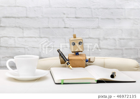 robot is sitting at the table, working place 46972135