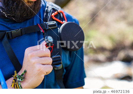 Torso of equipped hiker with speaker, compass and water pipe 46972136