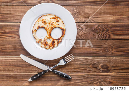 Pancake skull on wooden table 46973726