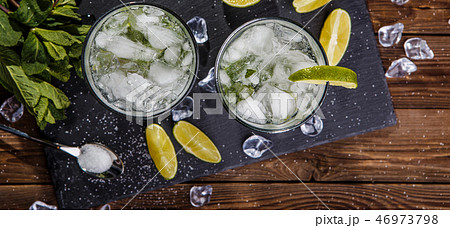 Two glasses with beverage, lemon Two glasses with beverage, lemon 46973798