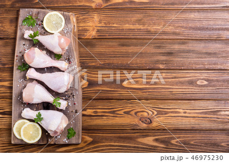 Raw chicken legs with spices and parsley Raw chicken legs with spices and parsley 46975230