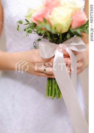 Close up bouquet of white and pink roses in bride hands. 46975989