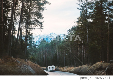 Mystical road in the forest with camper car riding Mystical road in the forest with camper car riding 46977421