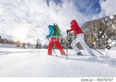 Snowshoe walkers running in powder snow with beautiful sunrise light. 46978707