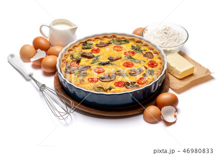 Baked homemade quiche pie in ceramic baking form, eggs and cream 46980833