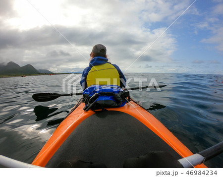 Image from back of female tourist with paddle on canoe floating Image from back of female tourist with paddle on canoe floating 46984234