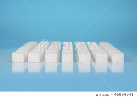 Sugar cubes vary position on light blue background 46984941