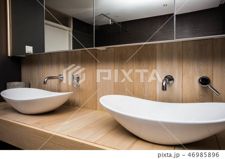 Two modern sink in the bathroom, and big mirror, new empty house Two modern sink in the bathroom, and big mirror, new empty house 46985896
