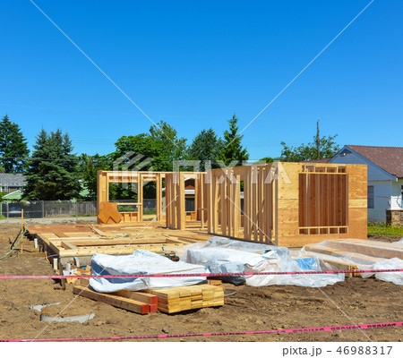 Single family home under construction on blue sky background 46988317