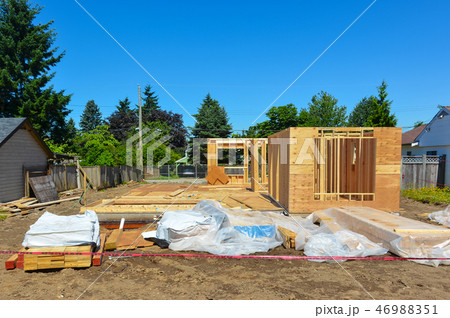 Single family home under construction on blue sky background Single family home under construction on blue sky background 46988351