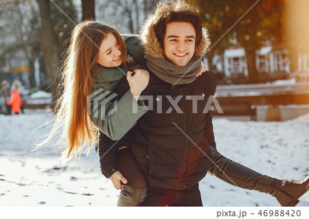 Loving couple walking in a winter park Loving couple walking in a winter park 46988420
