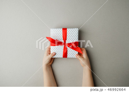 White gift box with red bow in the children hands 46992664
