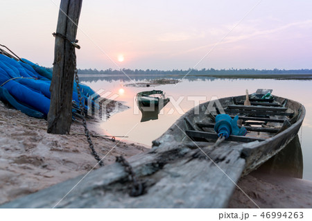 Fishing boat parking on riverside on sunset scene Fishing boat parking on riverside on sunset scene 46994263