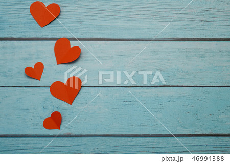 Red paper hearts on a blue wooden background Red paper hearts on a blue wooden background 46994388