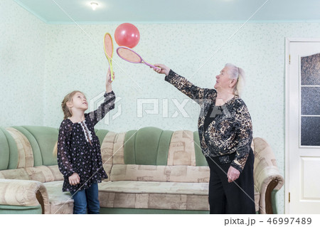 grandmother plays with the granddaughter of balloon 46997489