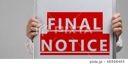 men's hands holding a poster with the inscription on a red background final notice isolated 46998465