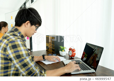 man work at home with her computer and paper 46999547