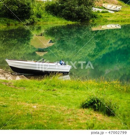 Little boat on water shore 47002799